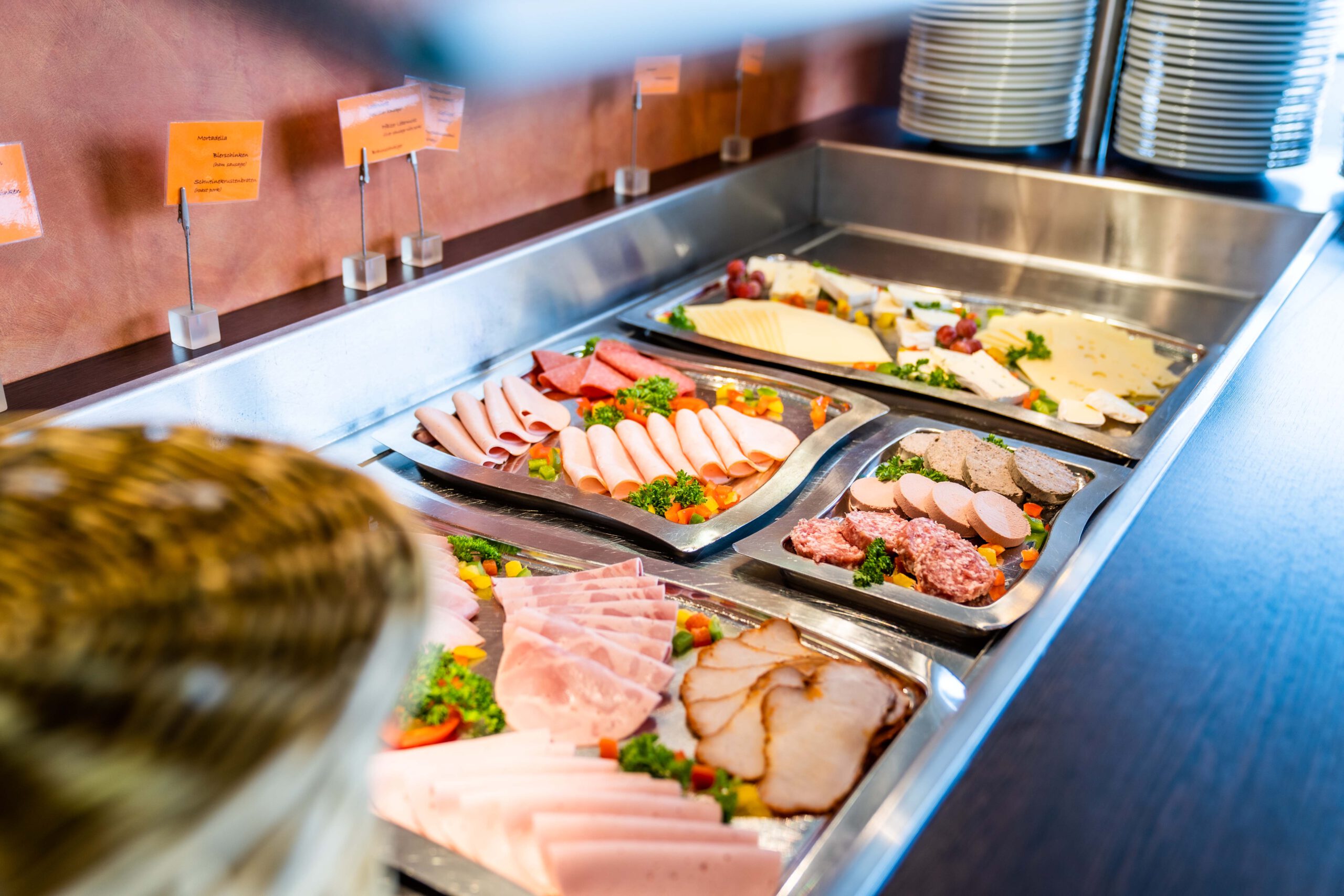 Selection of cold meats, cheese and fresh sides at the buffet