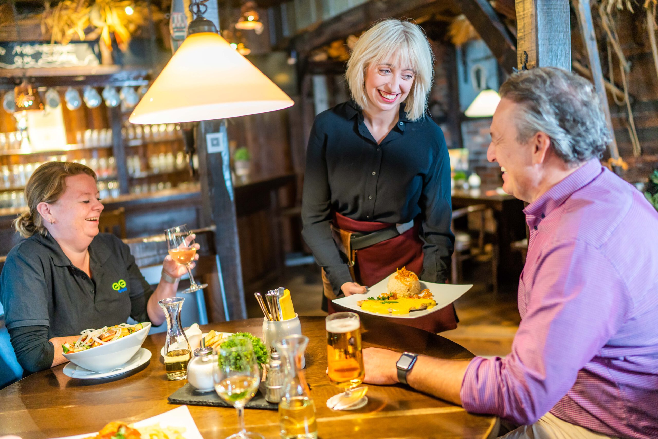 Guests being served freshly prepared meals in the tavern