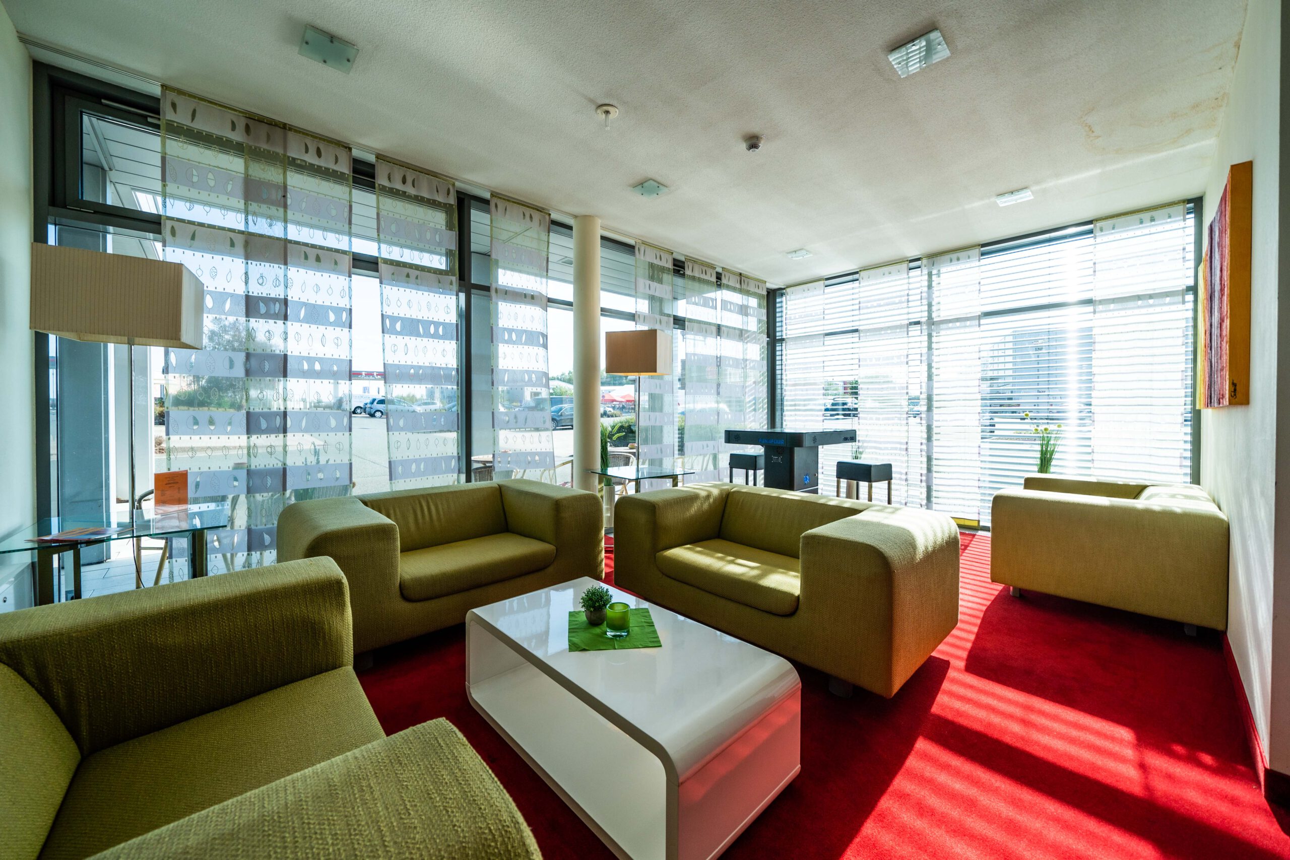 Relaxing in the hotel lounge Cozy lounge area with armchairs and natural light